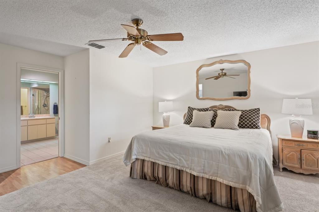 3274 Lori Lane, Unit 2 New Port Richey, FL 34655 - Photo 28 of 56 a bedroom with a bed and a chandelier