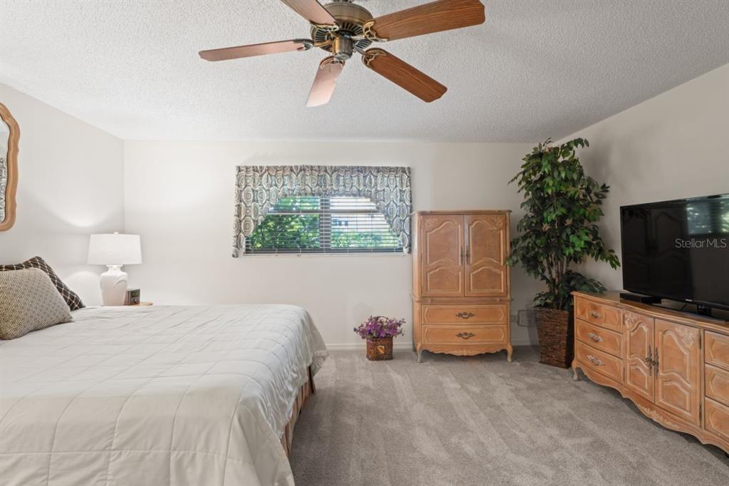 3274 Lori Lane, Unit 2 New Port Richey, FL 34655 - Photo 29 of 56 a bedroom with a bed and a flat screen tv