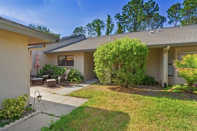 a view of a patio with table and chairs under an umbrella