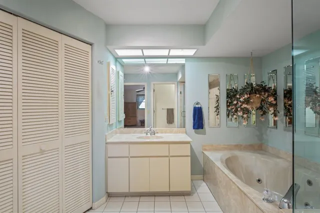 a bathroom with a granite countertop shower a mirror and a sink