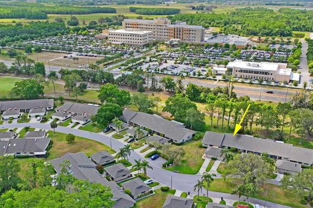 an aerial view of a house with a yard and lake view