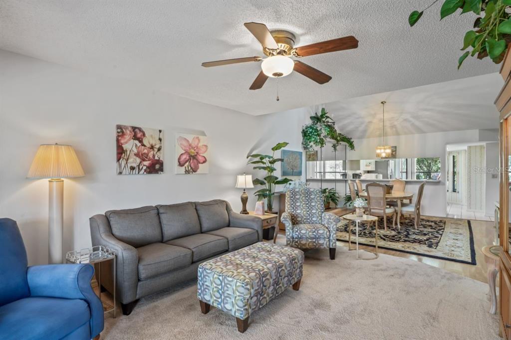 3274 Lori Lane, Unit 2 New Port Richey, FL 34655 - Photo 10 of 56 a living room with furniture and a chandelier