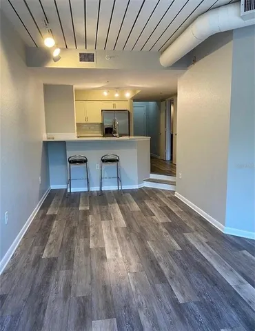 a view of a room with wooden floor
