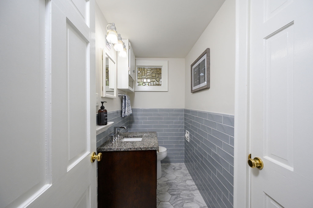 2 Hoover Road Hingham, MA 02043 - Photo 12 of 42 a bathroom with a granite countertop sink and a mirror
