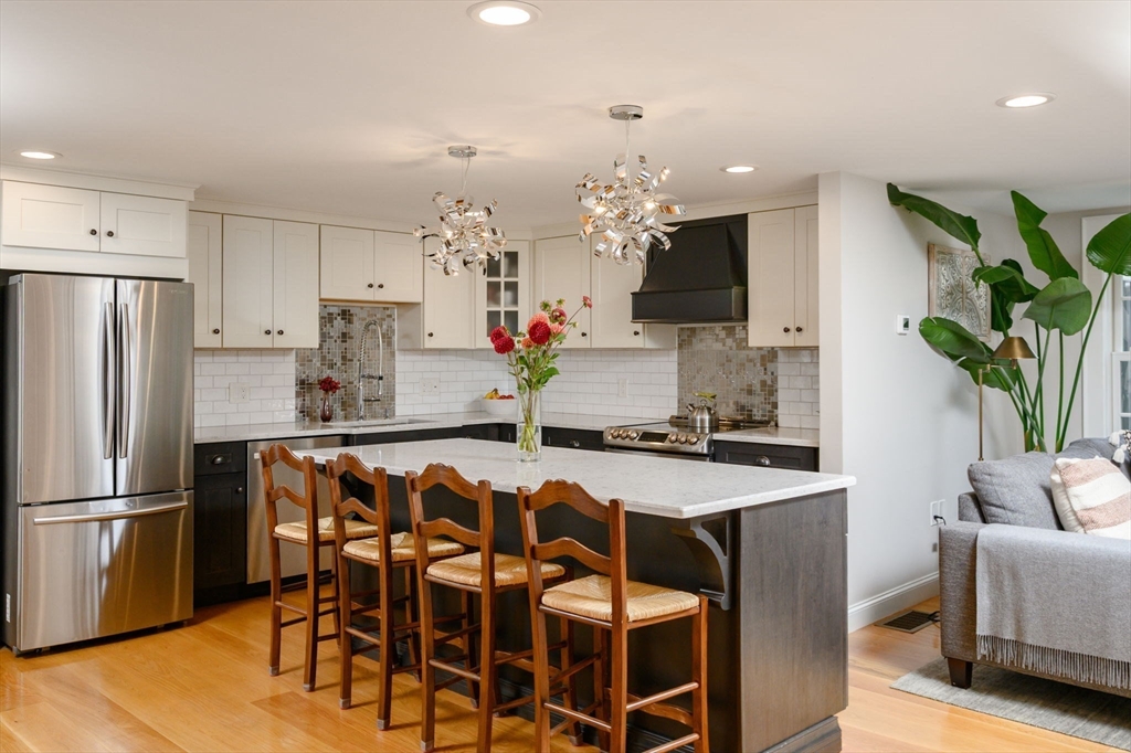 2 Hoover Road Hingham, MA 02043 - Photo 3 of 42 a kitchen with kitchen island granite countertop a table and chairs in it