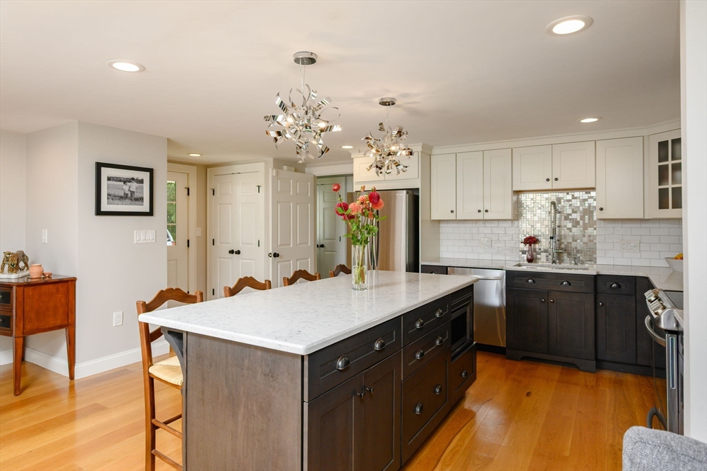 2 Hoover Road Hingham, MA 02043 - Photo 5 of 42 a kitchen with kitchen island granite countertop a sink cabinets and wooden floor