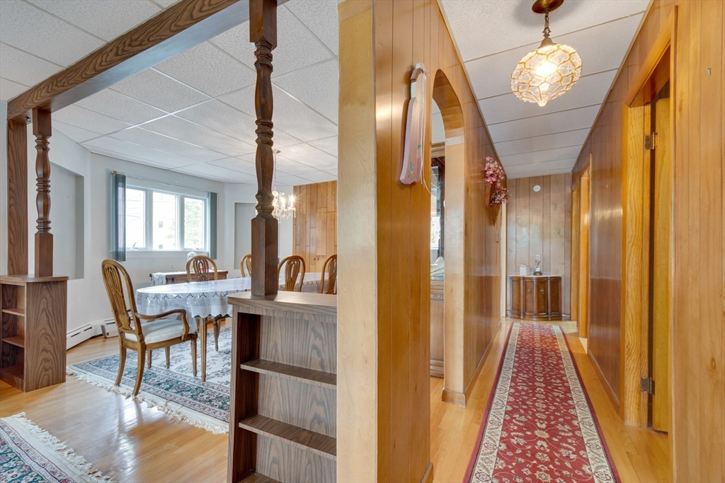 45 Jackson Road Somerville, MA 02145 - Photo 4 of 27 a dining room with furniture a chandelier and wooden floor