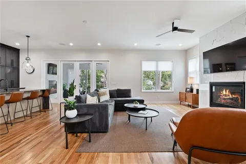 a large kitchen with stainless steel appliances kitchen island granite countertop a large center island attached withe living room