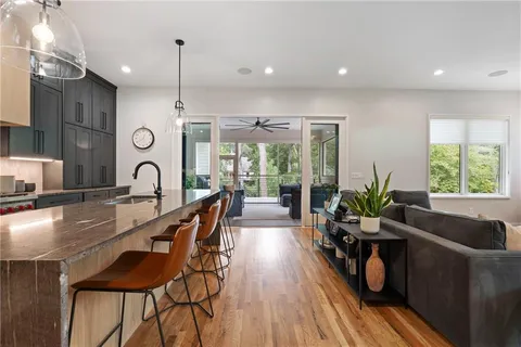 a living room with furniture and a floor to ceiling window