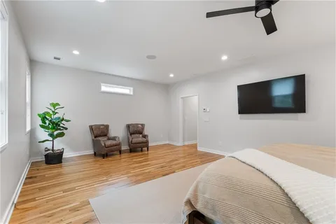 a spacious bathroom with a mirror sink and toilet