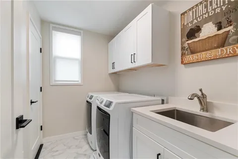 a living room with furniture a flat screen tv and kitchen view