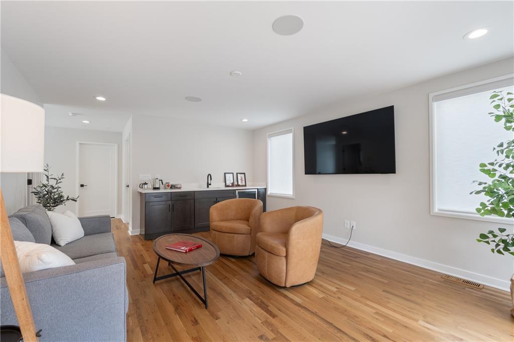 664 B Timm Valley Road Northeast Atlanta, GA 30305 - Photo 44 of 61 a living room with furniture a flat screen tv and kitchen view