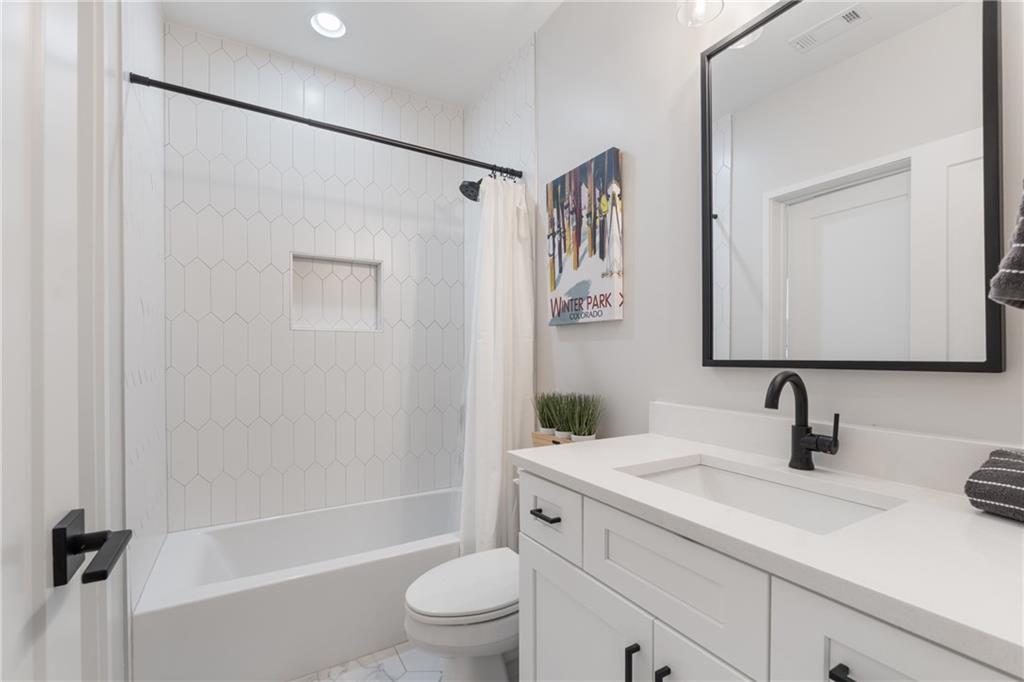 664 B Timm Valley Road Northeast Atlanta, GA 30305 - Photo 50 of 61 a bathroom with a granite countertop sink a mirror a shower and a toilet