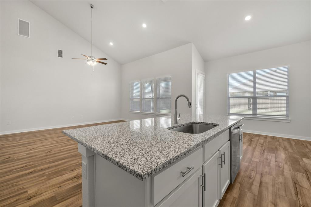 113 Shadow Oak Cove Georgetown, TX 78628 - Photo 13 of 40 A well-appointed kitchen island with gleaming counters, providing both functionality and a central gathering spot.