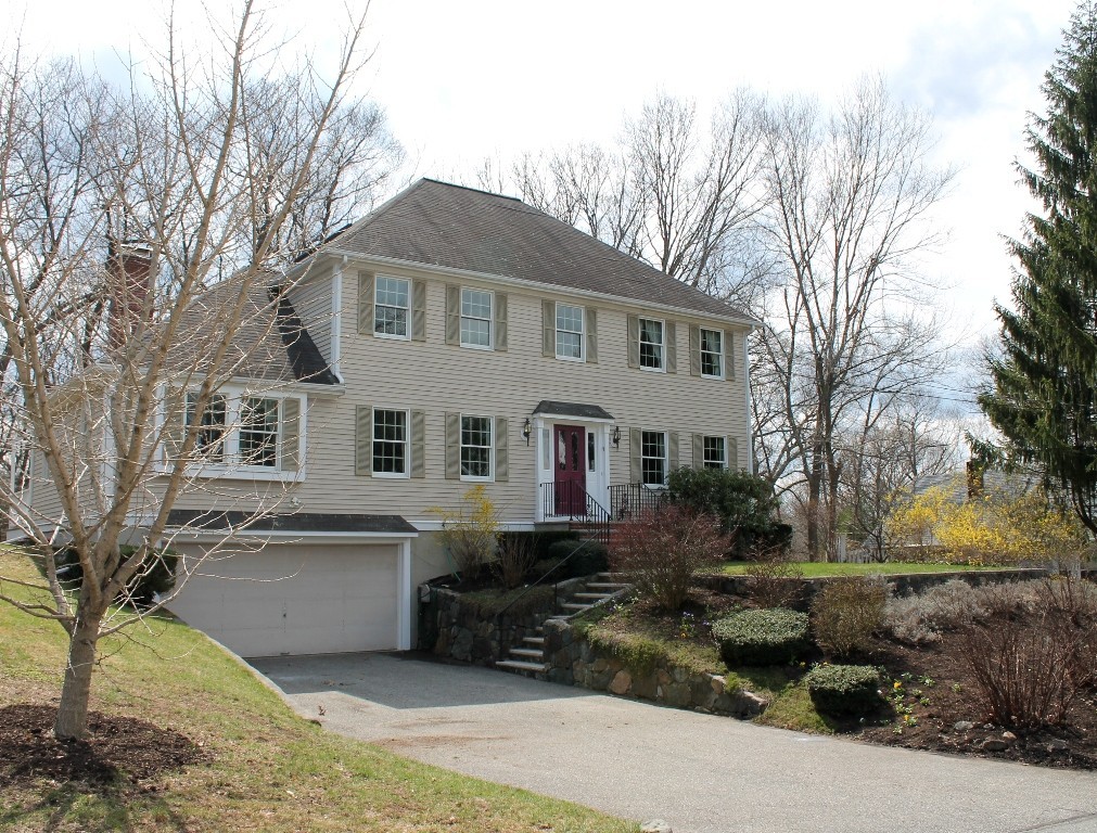 a front view of house with yard and trees around