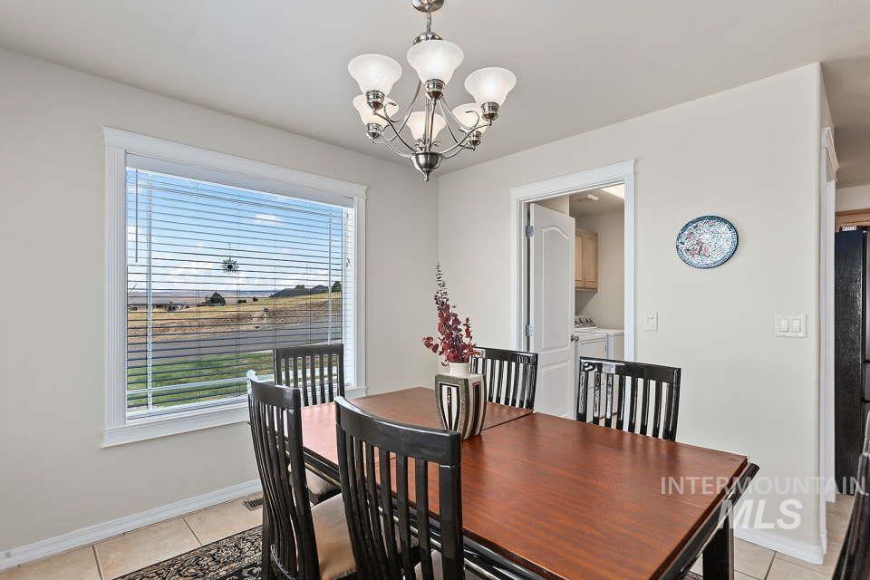 2924 27th Street Clarkston, WA 99403 - Photo 13 of 36 Dining area featuring a chandelier, light tile patterned floors, and washer and dryer