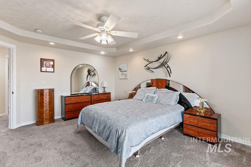 2924 27th Street Clarkston, WA 99403 - Photo 22 of 36 Bedroom featuring carpet floors, a tray ceiling, recessed lighting, and a ceiling fan