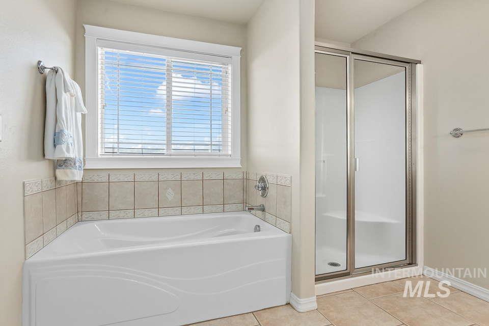 2924 27th Street Clarkston, WA 99403 - Photo 25 of 36 Bathroom with a garden tub, tile patterned flooring, and a stall shower