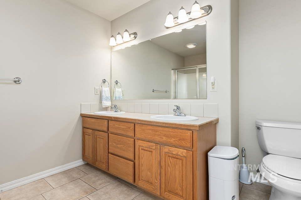 2924 27th Street Clarkston, WA 99403 - Photo 27 of 36 Full bath featuring tile patterned floors, double vanity, and a shower stall