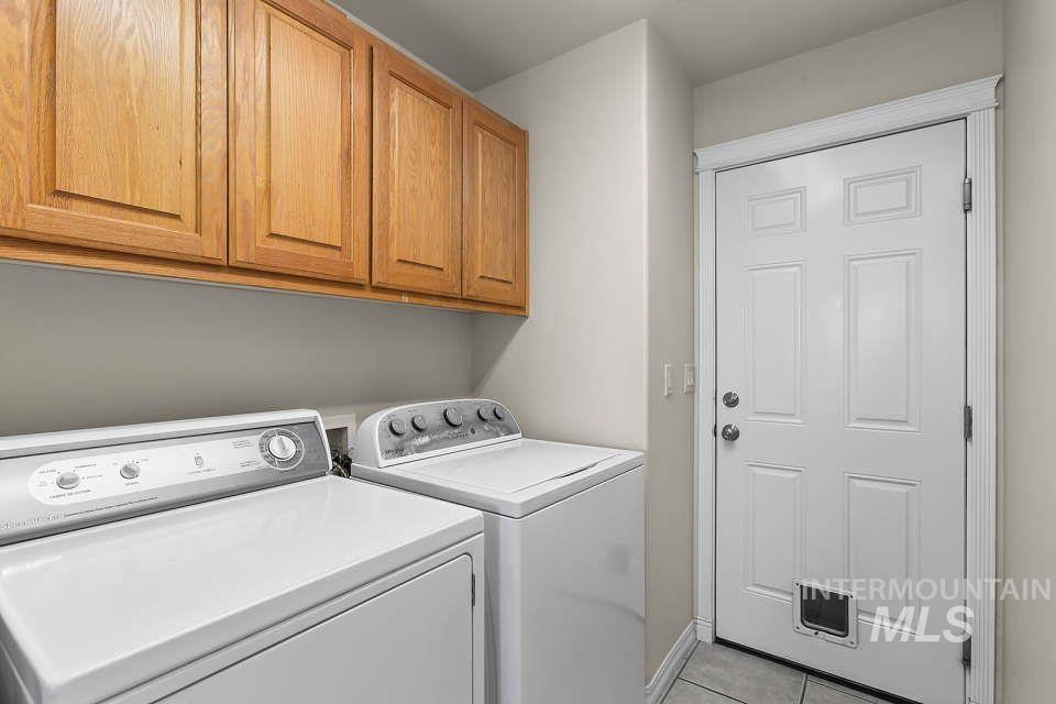 2924 27th Street Clarkston, WA 99403 - Photo 28 of 36 Washroom with cabinet space, washer and dryer, and light tile patterned floors