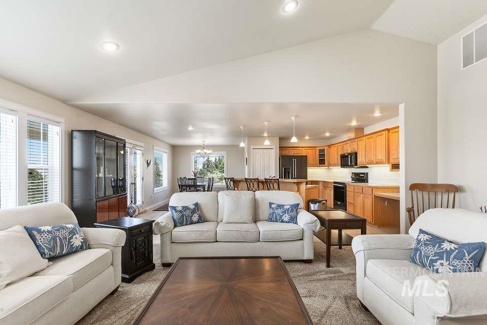 2924 27th Street Clarkston, WA 99403 - Photo 8 of 36 Living room with lofted ceiling, a chandelier, light carpet, and recessed lighting
