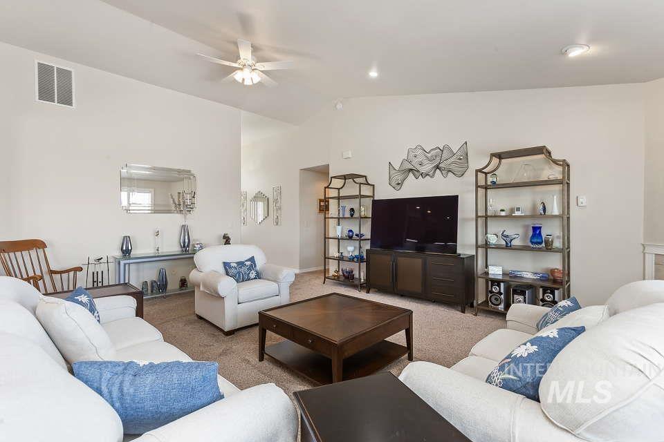 2924 27th Street Clarkston, WA 99403 - Photo 9 of 36 Living room with lofted ceiling, a ceiling fan, and light carpet
