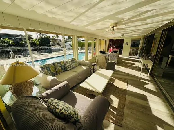 a living room with furniture and a floor to ceiling window