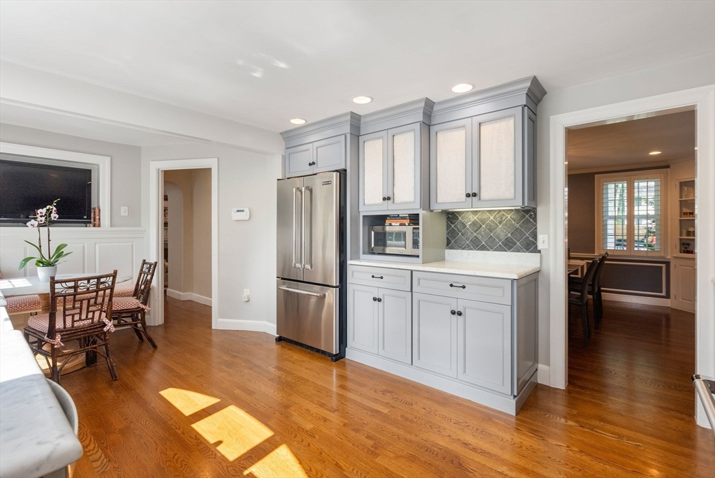 88 Albion Road Wellesley, MA 02481 - Photo 12 of 27 a kitchen with white cabinets and stainless steel appliances