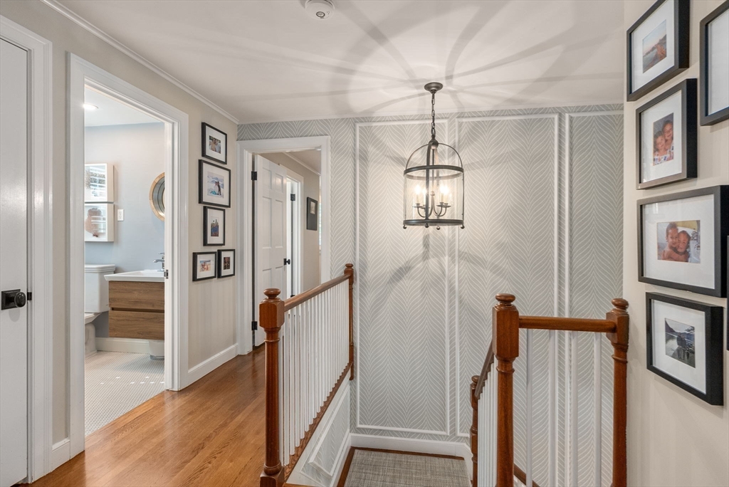 88 Albion Road Wellesley, MA 02481 - Photo 17 of 27 a view of a hallway with a chandelier