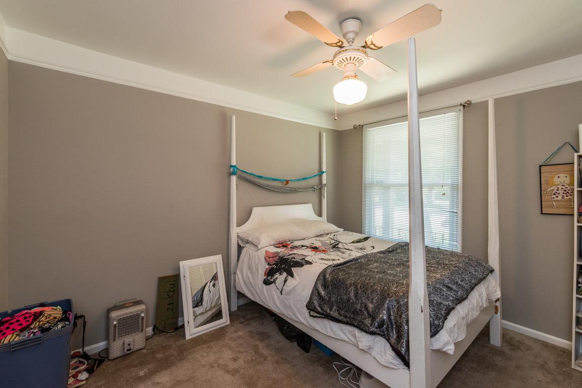 518 Rural Hill Road Nashville, TN 37217 - Photo 11 of 18 a bedroom with a bed and a chandelier