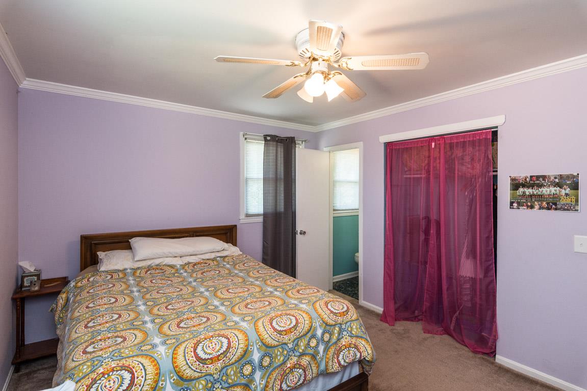 518 Rural Hill Road Nashville, TN 37217 - Photo 8 of 18 a bedroom with a bed and a chandelier
