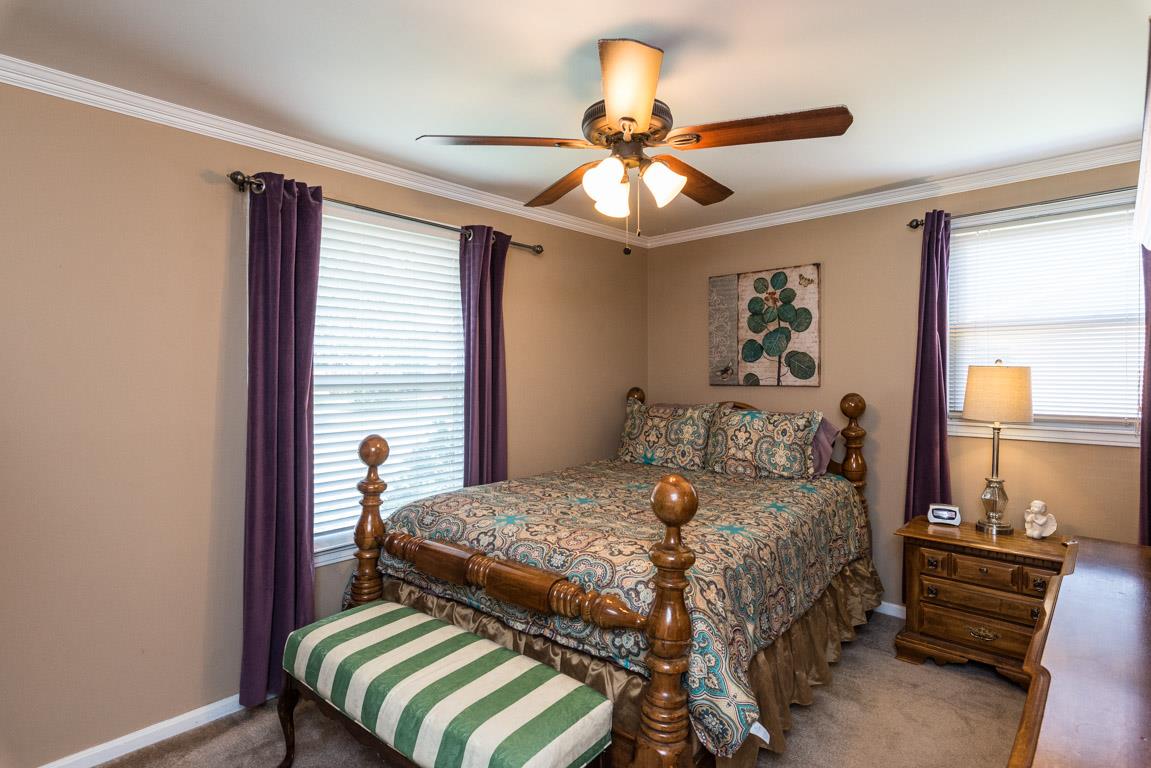 518 Rural Hill Road Nashville, TN 37217 - Photo 10 of 18 a bedroom with a bed and a chandelier