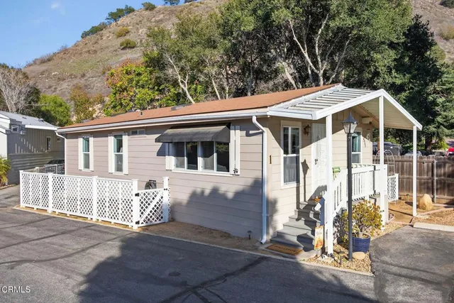 a view of a patio with a table and chairs under an umbrella