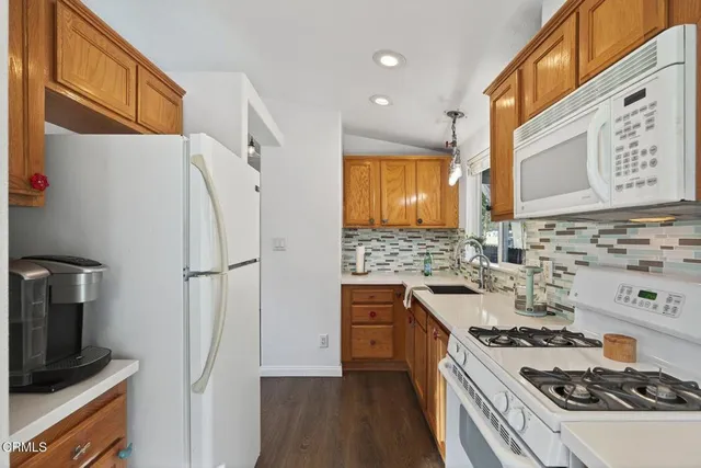 a kitchen with stainless steel appliances a refrigerator and a stove top oven