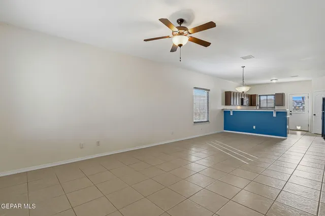 an empty room with projector and outdoor space