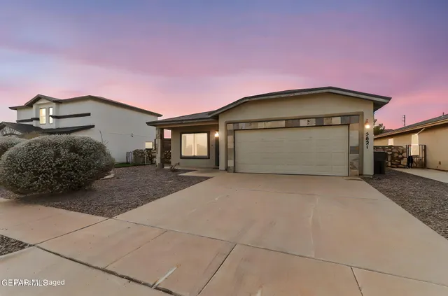 a front view of a house with a garage