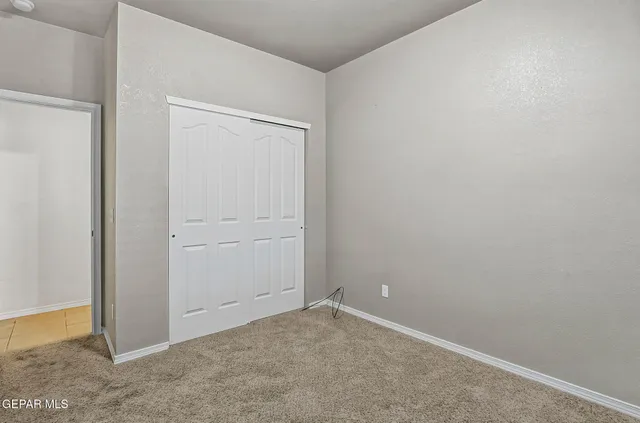 a bedroom with bed and a potted plant