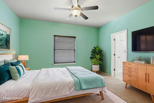 an empty room with closet and windows