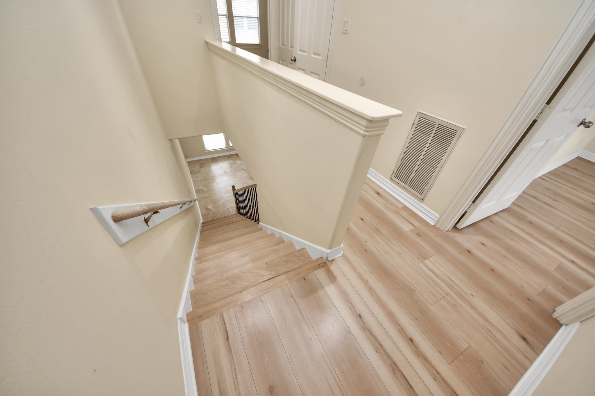 13038 Gentryside Court Houston, TX 77077 - Photo 11 of 20 Beautifully updated staircase featuring modern wood laminate flooring.