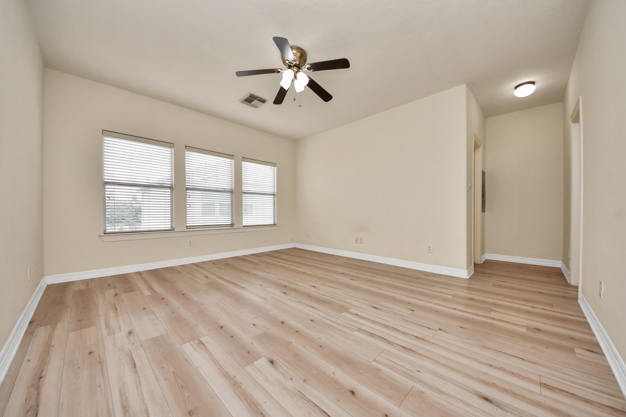 13038 Gentryside Court Houston, TX 77077 - Photo 14 of 20 Spacious primary retreat with large windows for natural light and warm wood laminate flooring