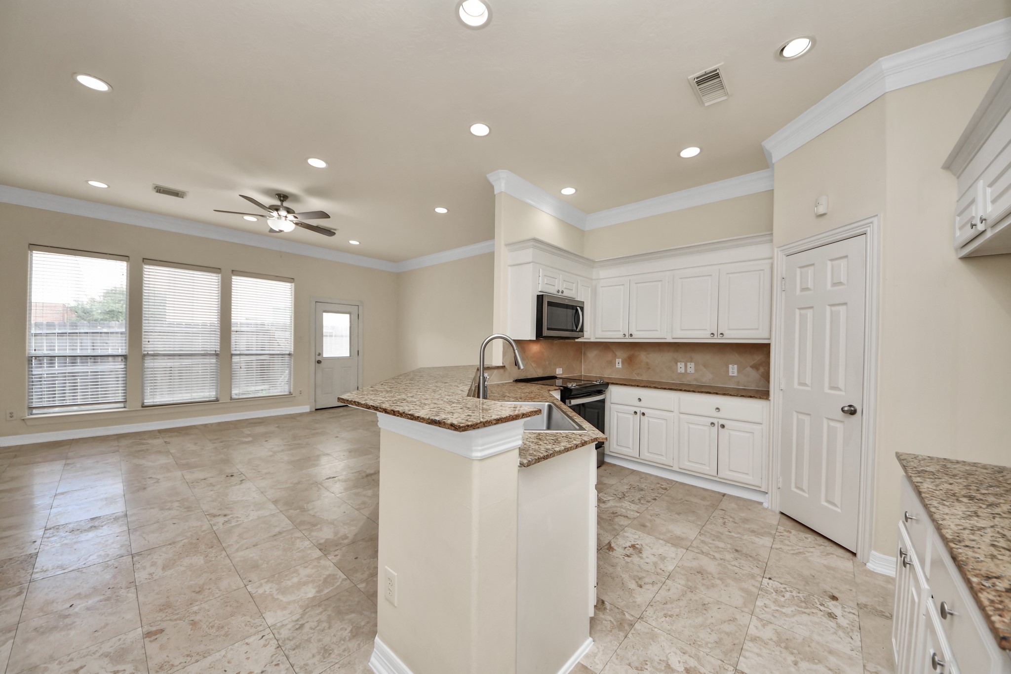13038 Gentryside Court Houston, TX 77077 - Photo 6 of 20 The open kitchen overlooks the light-filled living room, creating a bright and inviting space for everyday living and entertaining.