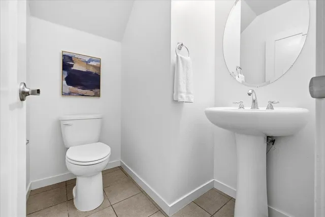 a bathroom with a sink toilet and a mirror