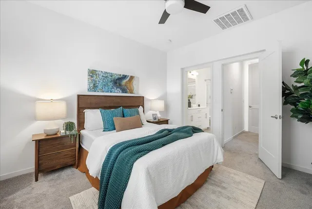 a bedroom with a bed and a painting on the wall