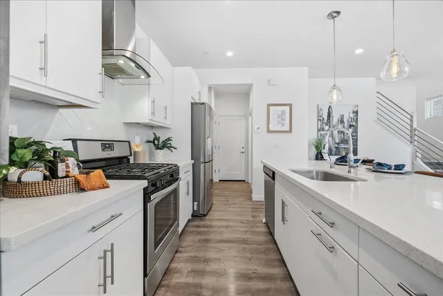 a kitchen with stainless steel appliances granite countertop a sink and cabinets