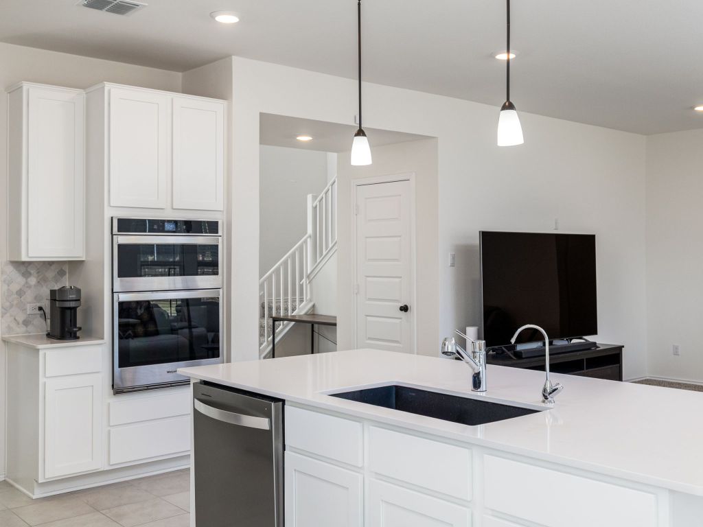 3921 Riardo Drive Round Rock, TX 78665 - Photo 11 of 27 a kitchen with a sink and a stove top oven