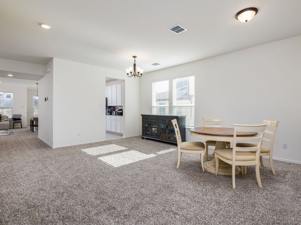 3921 Riardo Drive Round Rock, TX 78665 - Photo 12 of 27 a living room with furniture a chandelier and a window