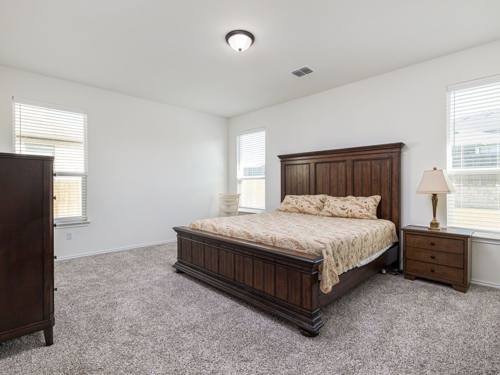 3921 Riardo Drive Round Rock, TX 78665 - Photo 14 of 27 a large bed sitting in a room next to a window