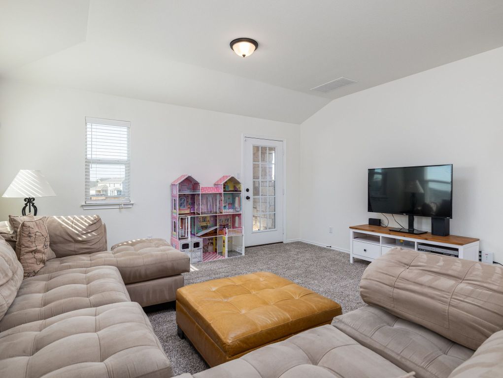 3921 Riardo Drive Round Rock, TX 78665 - Photo 21 of 27 a living room with furniture and a flat screen tv