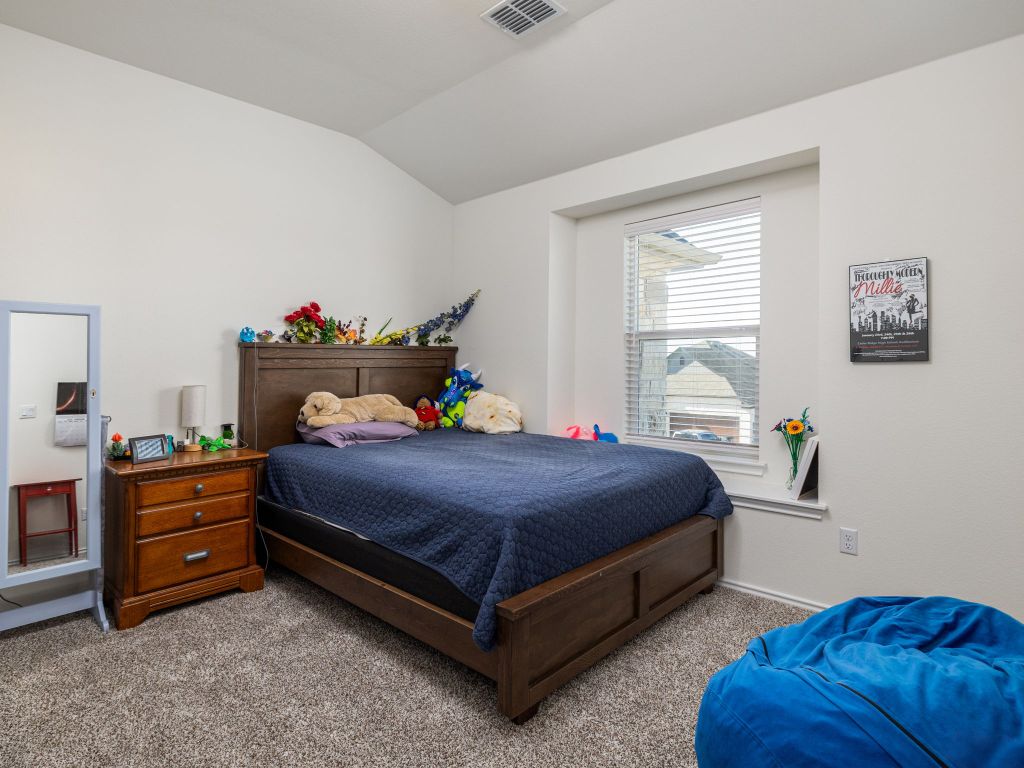 3921 Riardo Drive Round Rock, TX 78665 - Photo 23 of 27 a bedroom with a bed and a window