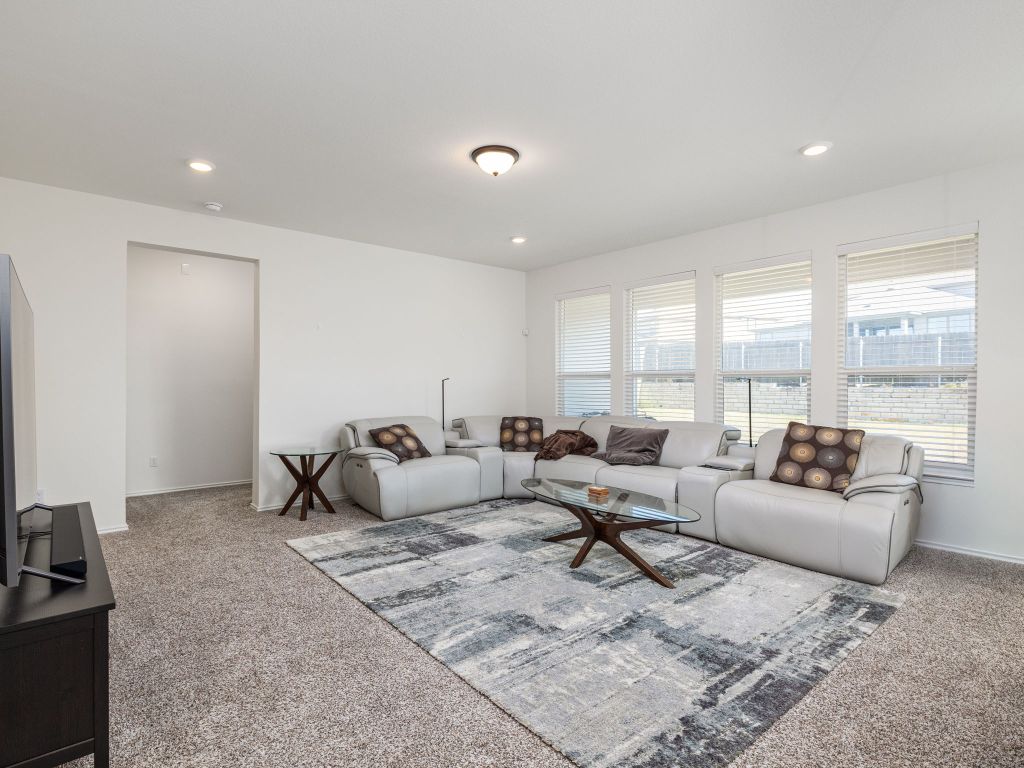 3921 Riardo Drive Round Rock, TX 78665 - Photo 5 of 27 a living room with furniture rug and large window